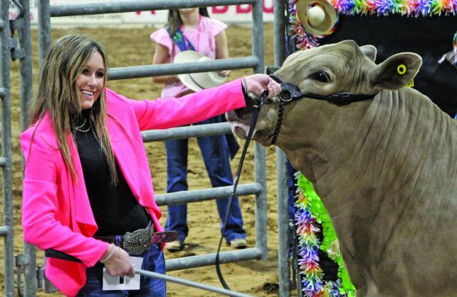 Sentinel photo/MaLinda Reddell Van Vleck FFA member Kenzie Brown is all smiles as she shows the Grand Champion steer at the 2022 Matagorda County Fair & Livestock Association (MCFLA) Junior Livestock Auction she sold for $11,000 Saturday, March 5.