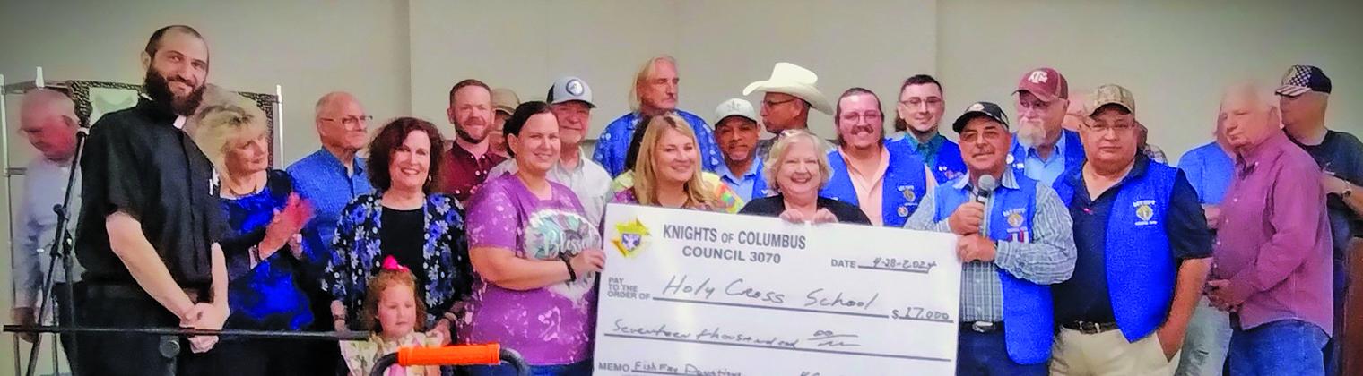 Rhonda Westbrook photo Holy Cross Catholic School received a $17,000 check from Bay City Knights of Columbus Council 3070 from this year's "Lenten Catfish Fries." The check was presented to HCCS's principal, Linda Bradford, at the annual HCCS Spring Bazaar on April 28.